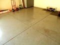 Why are there score line grooves in the concrete floor of the garage?