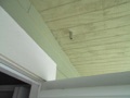 What is the small pipe sticking out of the eaves/soffit under the roof overhang?