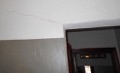 How can I tell if a diagonal crack in drywall at the corner of a window or door indicates a structural problem?