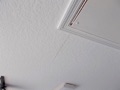What causes drywall cracks in the ceilings and walls of a house?