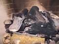 What causes black soot buildup on my gas fireplace logs?