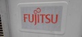 How can I tell the age of a Fujitsu air conditioner from the serial number?