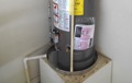 What are the special code requirements for installation of a gas water heater in a garage?
