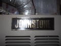 How can I tell the age of a Johnstone air conditioner or furnace from the serial number?