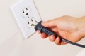 What is the difference between an electrical receptacle, an outlet, and a plug?