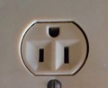 Why are some electric receptacle outlets upside down (ground slot up) in a house?