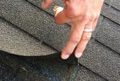 What does lack of tab adhesion in an asphalt shingle roof mean?