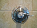 When were shower control valves first required by code to be pressure balanced and temperature limiting (single handle)?