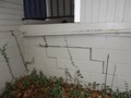 What causes cracks in the walls and floors of a house?