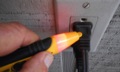 How does a home inspector use a tic-tracer (non-contact voltage tester) for safety when doing electrical inspections?