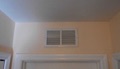 What is the purpose of the vent grille over the bedroom door?