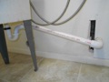 What is the minimum and maximum slope of the trap arm of a plumbing drain?