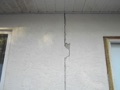 How can I tell if a crack in a stucco wall is a structural problem and what is causing it?