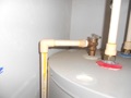 What are the code requirements for the discharge piping from a Temperature-Pressure Relief (TPR) valve at a water heater?